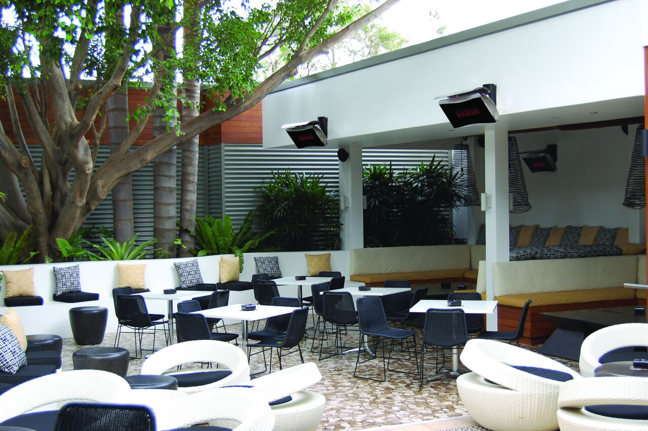 Bromic Platinum gas heaters mounted above a restaurant patio with white lounge seating