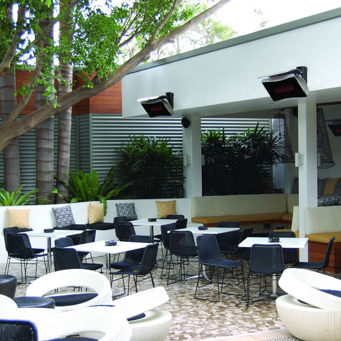 Bromic Platinum gas heaters mounted above a restaurant patio with white lounge seating