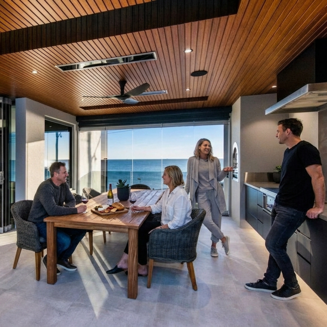 Family dining at an indoor-outdoor room warmed by recessed Bromic Platinum electric heaters
