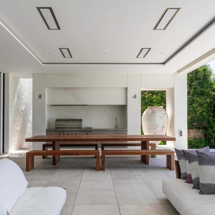 Four Bromic Platinum electric heaters recessed flush into the ceiling of a covered outdoor dining and lounge room
