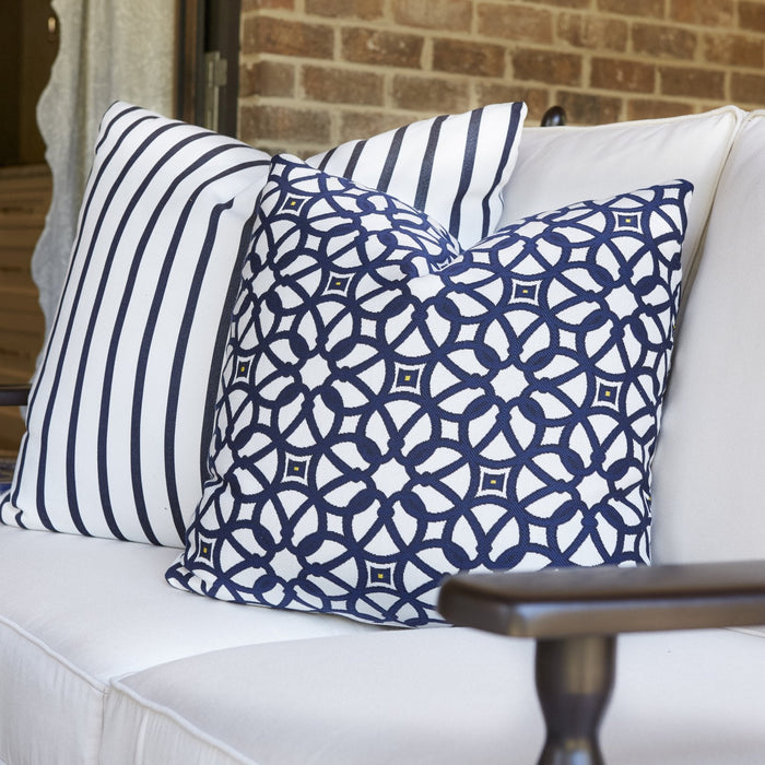 Navy lattice and navy stripe throw pillows on white Lloyd Flanders Low Country seating