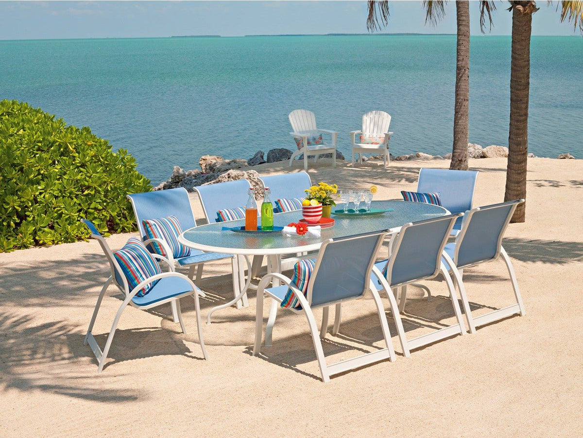 Telescope Casual Aruba II sling dining chairs around a table on a beach
