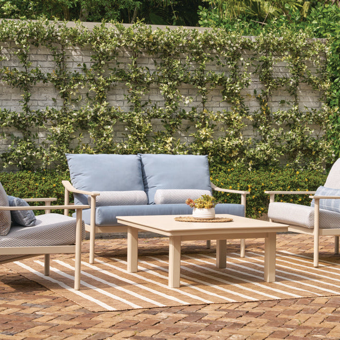 Telescope Casual Chateau loveseat and two club chairs on a brick patio