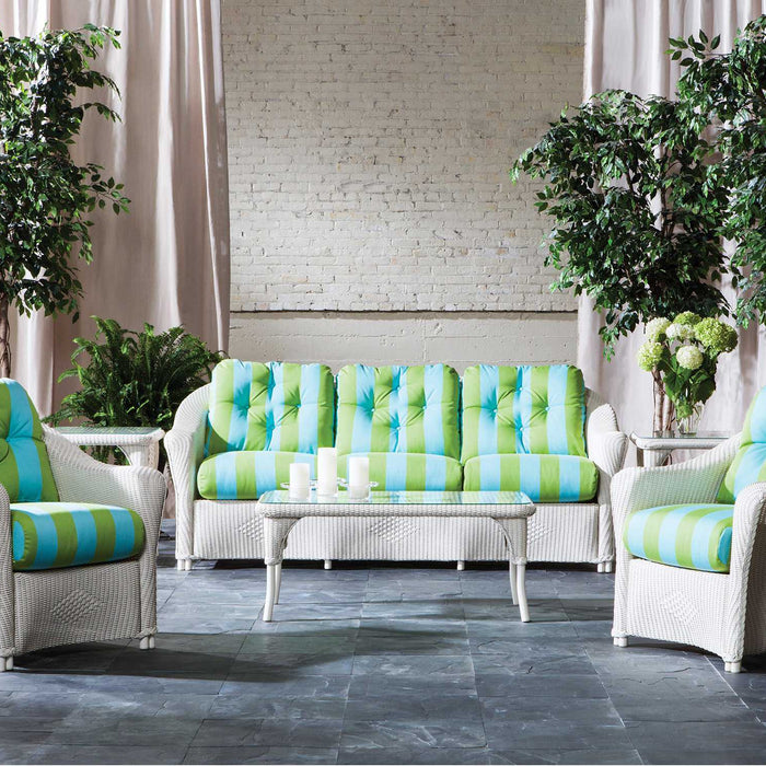 Lloyd Flanders Reflections Lloyd Loom sofa and lounge chairs with green striped cushions on a stone terrace
