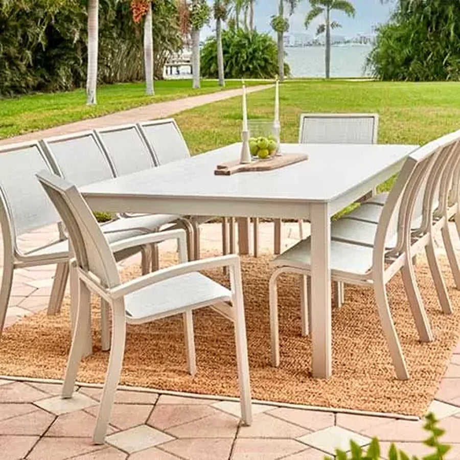 Telescope Casual Bazza sling dining chairs around a long dining table on a garden patio
