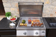 Built-In 700 Series 32 griddle in an outdoor kitchen with vegetables and fish