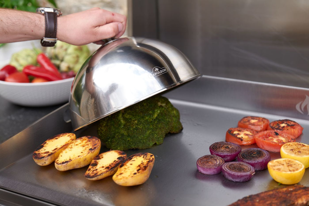 Steaming vegetables under a dome on the griddle