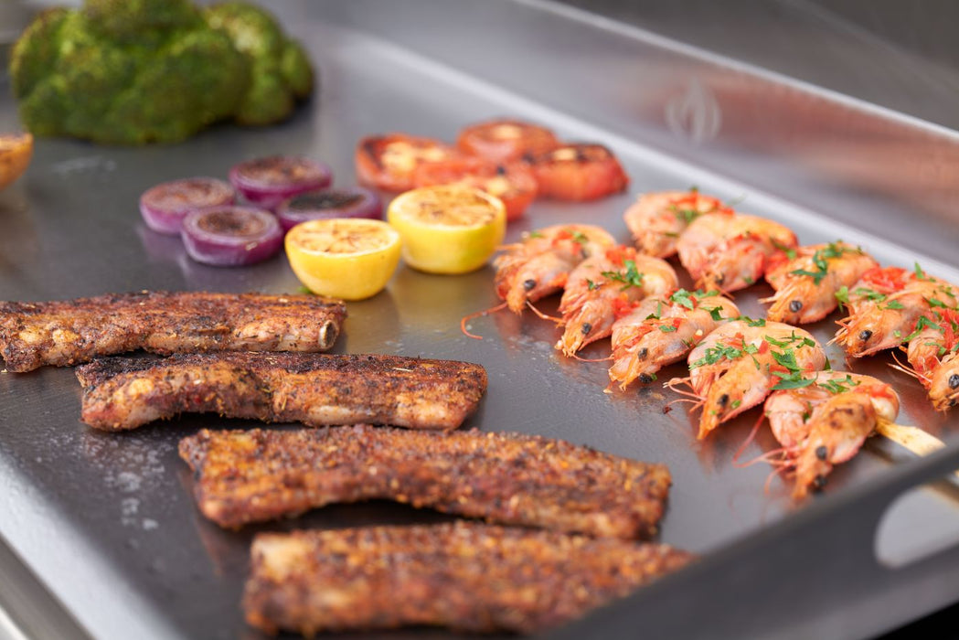 Shrimp, fish and vegetables on the 5 mm stainless steel surface