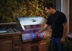 Grilling at dusk on the Built-In 700 Series 32 with night-light knobs