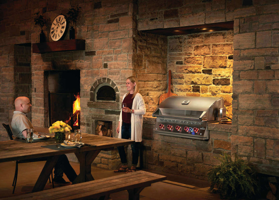 Built-In 700 Series 38 beside a wood-fired oven and dining table