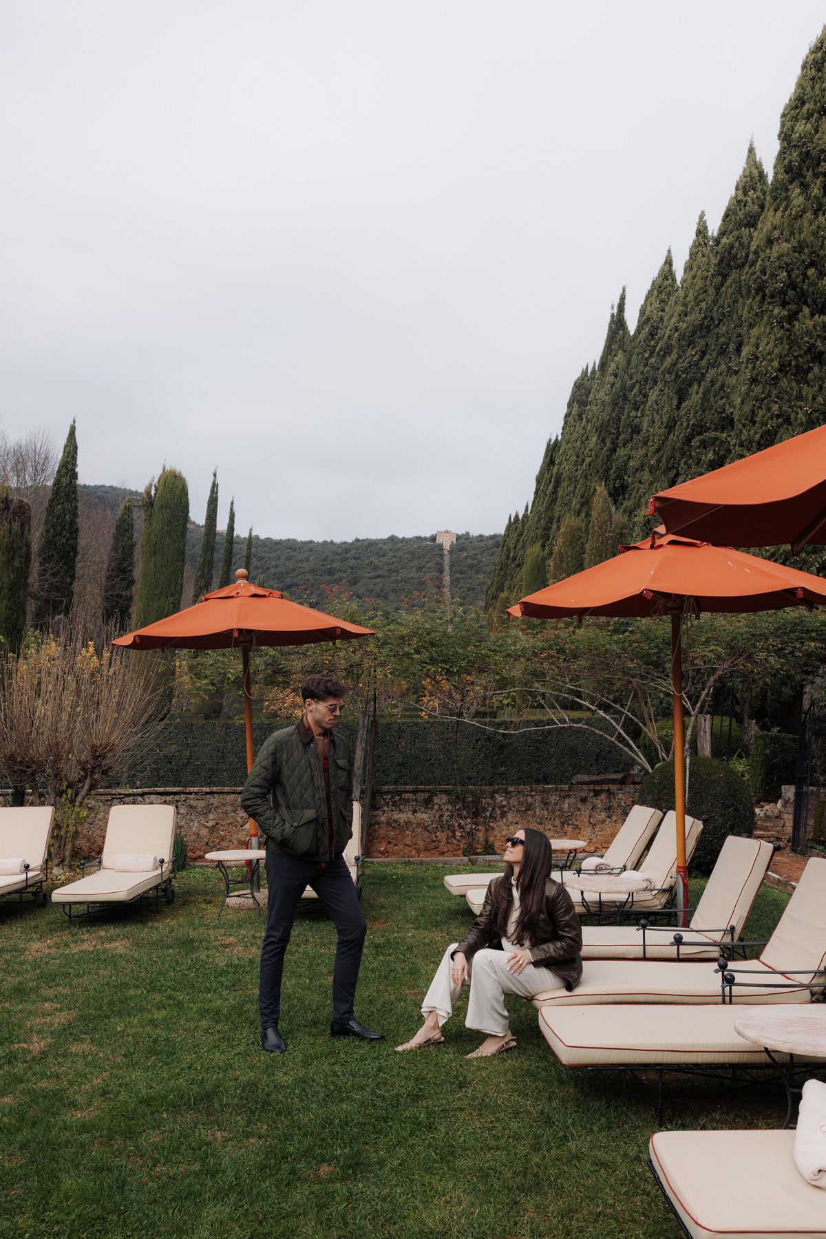 Emmett and Allison, the founders of Bespoke Patio, in a garden with outdoor furniture