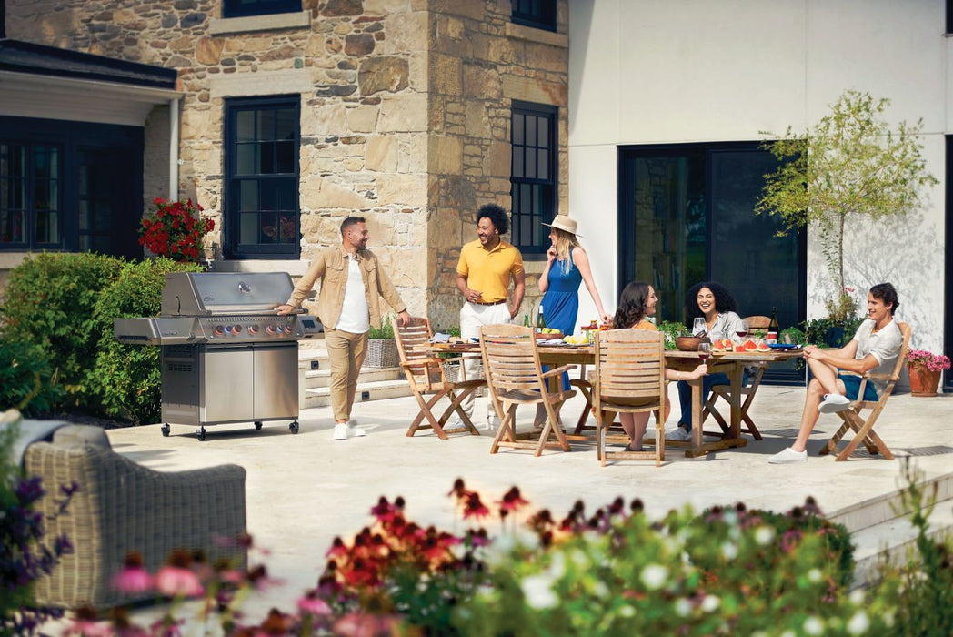 Friends gathered around the Prestige 665 Connected on a patio