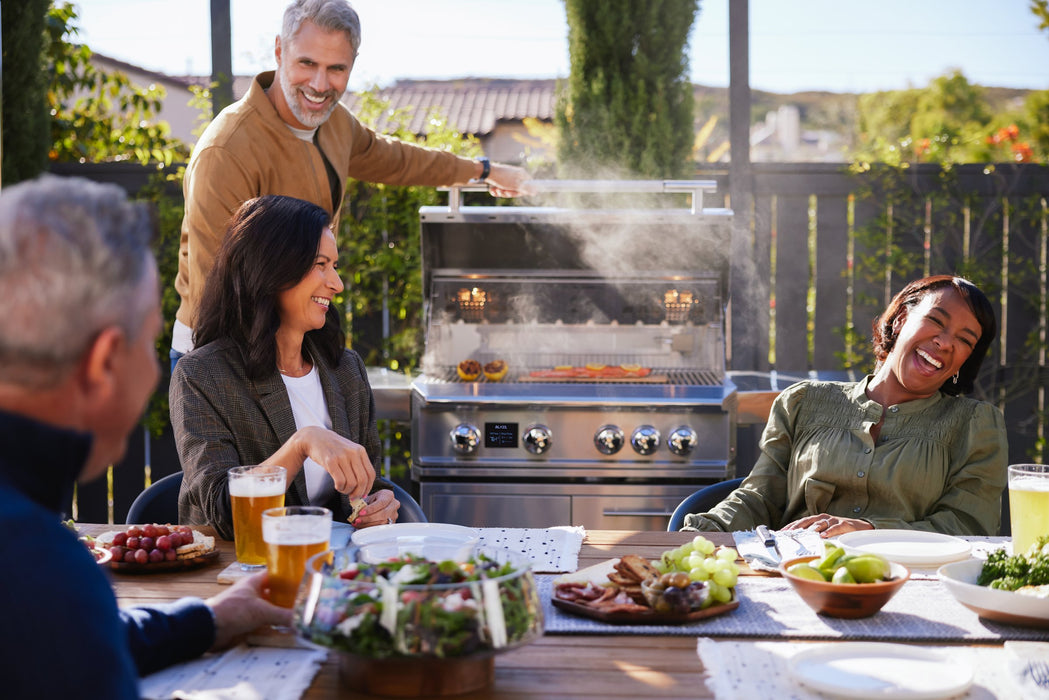 Blaze LTE PRO 32" Built-In Gas Grill - shown on its freestanding cart at an outdoor dinner