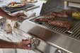 Blaze Professional LUX 44-inch built-in gas grill, in an outdoor kitchen, grilling steaks