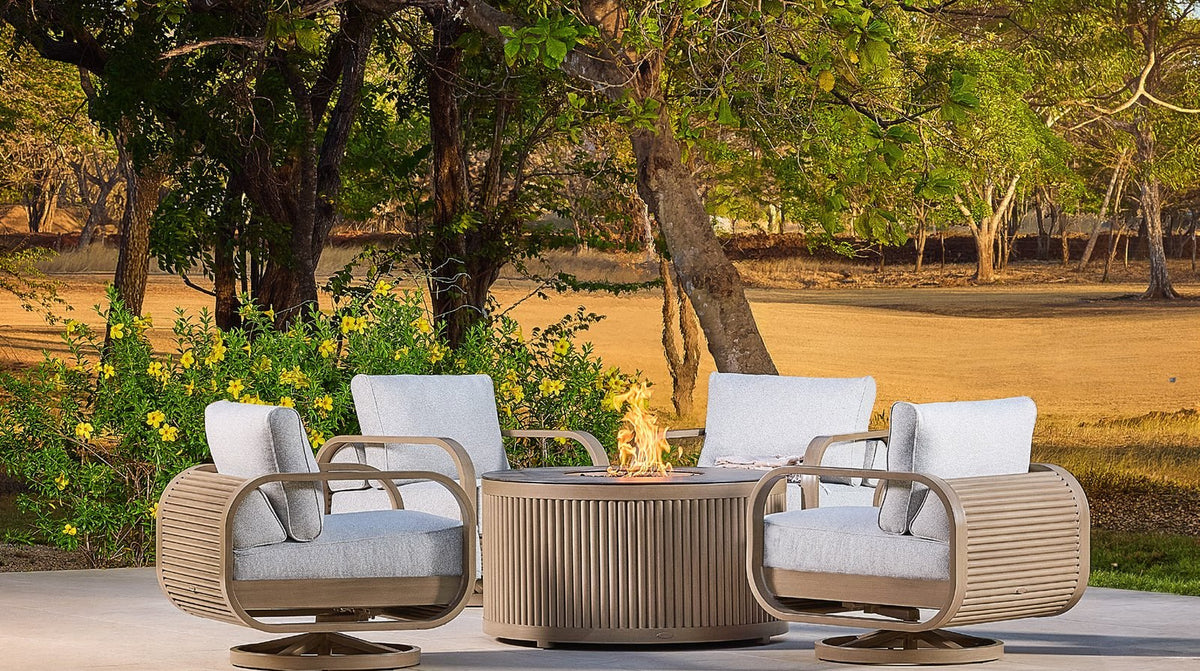 Castelle lounge chairs around a fire table under shade trees