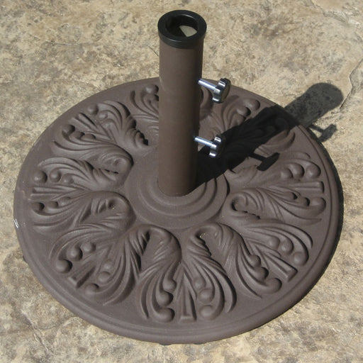 Galtech cast iron umbrella base in antique bronze on a stone patio