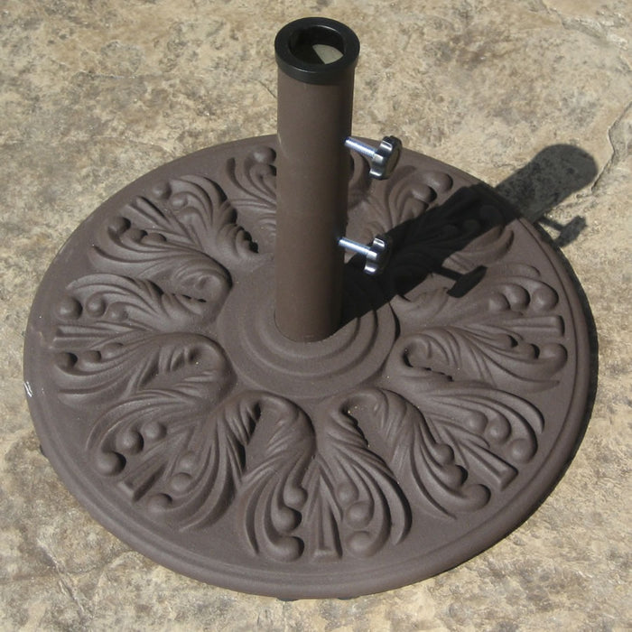 Galtech cast iron umbrella base in antique bronze on a stone patio