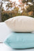 Stacked Lloyd Flanders square throw pillows in cream and aqua