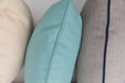 Close-up of Lloyd Flanders throw pillow welt details in cream, aqua and gray