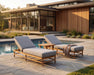 Two Woodard Brit adjustable chaise lounges by a pool (side table sold separately)