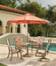 Telescope Casual round Cascade MGP dining table in Beachwood with sling dining chairs and an umbrella by a pool