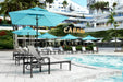 Homecrest Blair sling chaise lounges by a resort pool
