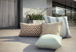 Homecrest outdoor throw and kidney pillows on a terrace