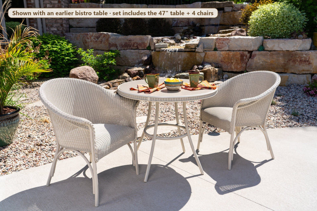 All Seasons dining armchairs on a patio (shown with an earlier bistro table; set includes the 47" table and 4 chairs)