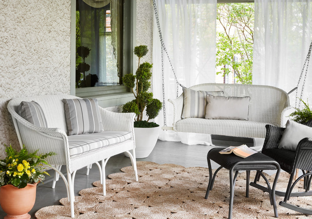 Lloyd Flanders All Seasons settee and settee swing in Ivory on a porch