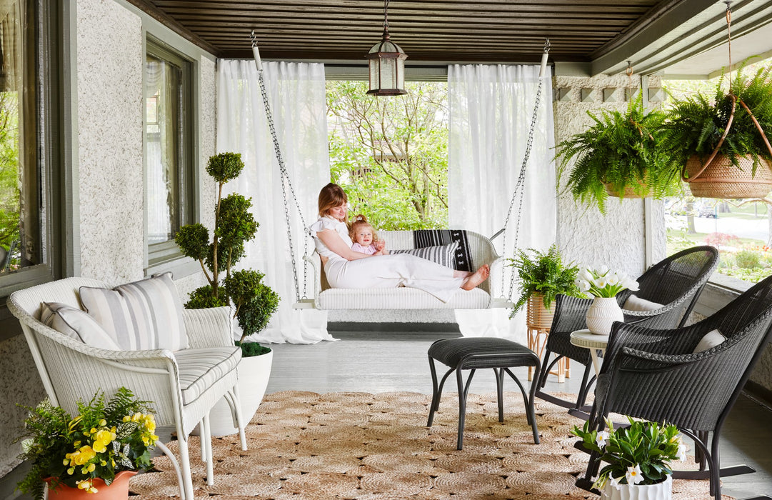 Lloyd Flanders All Seasons settee swing on a covered porch