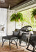 Lloyd Flanders All Seasons rocker and ottoman in Charcoal on a porch