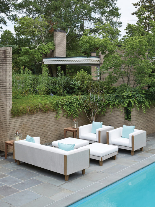 Lloyd Flanders Catalina seating in Linen beside a pool
