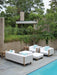 Lloyd Flanders Catalina seating in Linen beside a pool
