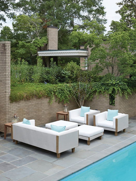 Lloyd Flanders Catalina sofa, ottomans and lounge chairs in Linen beside a pool