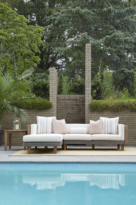 Lloyd Flanders Catalina sectional with chaise in Pewter beside a pool