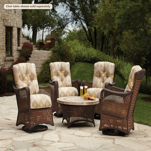 Lloyd Flanders Grand Traverse 4-Piece Swivel Glider Set on a patio (Chat table shown sold separately)