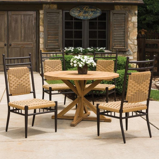 Lloyd Flanders Low Country 5-Piece Round Teak Dining Set on a patio