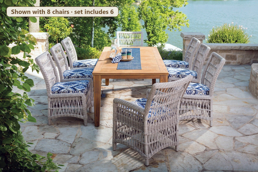 Lloyd Flanders Mackinac 7-piece teak dining set by a lake (shown with 8 chairs; set includes 6)