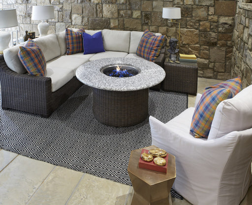 Lloyd Flanders Mesa L-shape sectional with the Mesa round fire table