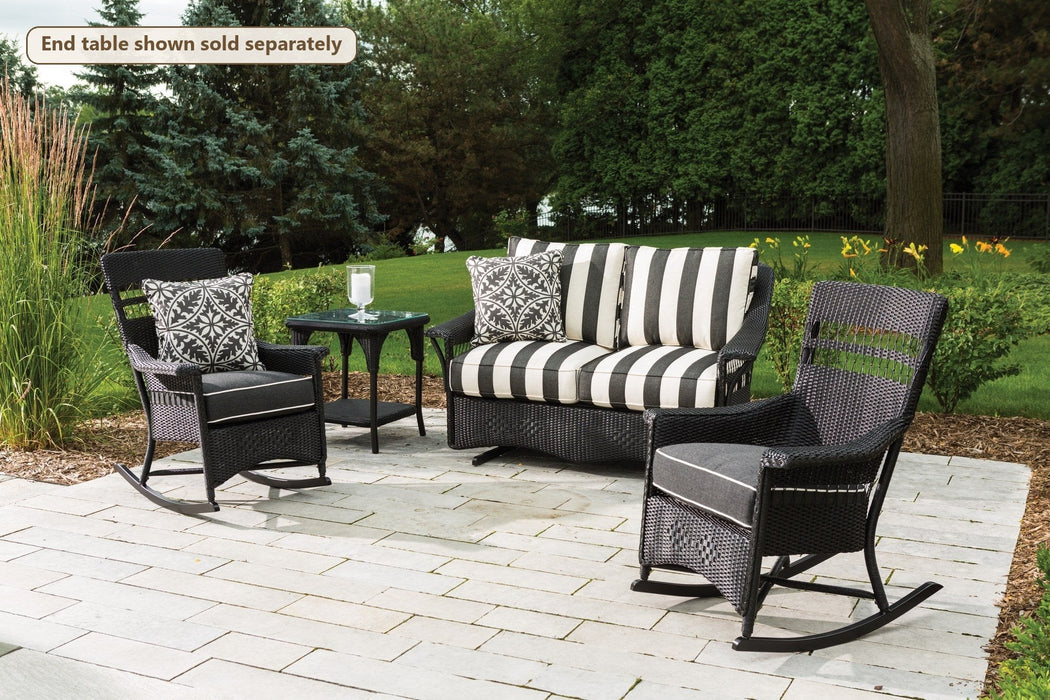 Lloyd Flanders Nantucket 3-Piece Glider Porch Set on a patio (End table shown sold separately)