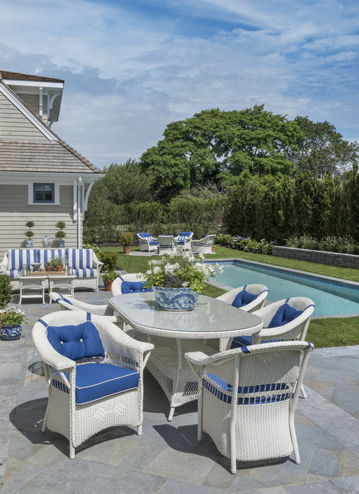 Lloyd Flanders Nantucket dining armchairs in Ivory by a pool