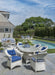 Lloyd Flanders Nantucket dining armchairs in Ivory by a pool