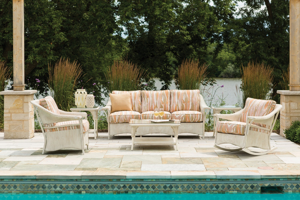 Lloyd Flanders Nantucket sofa and lounge chairs in Antique White by a pool