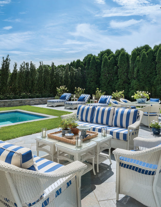 Lloyd Flanders Nantucket sofa and lounge chairs in Ivory by a pool