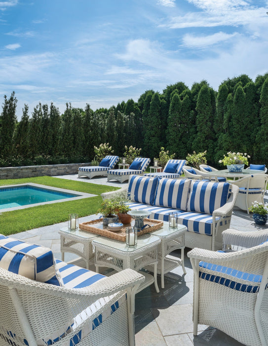 Lloyd Flanders Nantucket sofa and lounge chairs in Ivory by a pool