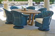 Lloyd Flanders Reflections swivel rocker dining armchairs around a teak table by a pool (some pieces shown are not included)