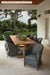Lloyd Flanders Reflections dining armchairs around a long teak table (shown with padded seats; set includes cushioned armchairs)