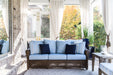 Lloyd Flanders Reflections sofa in Bark on a screened porch