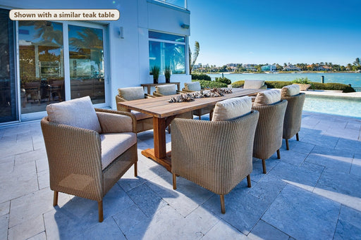Lloyd Flanders Visions 9-Piece Teak Dining Set on a patio (Shown with a similar teak table)