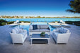 Lloyd Flanders Visions sofa and two lounge chairs in Matte White by a pool (cocktail table sold separately)